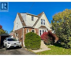 A house with a white car parked in front.