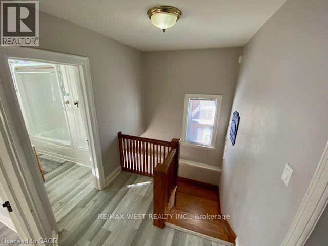 A room with a wooden floor and a window.