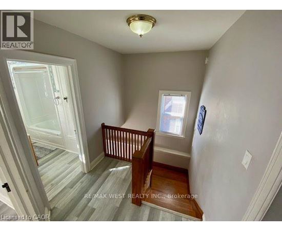 A room with a wooden floor and a window.