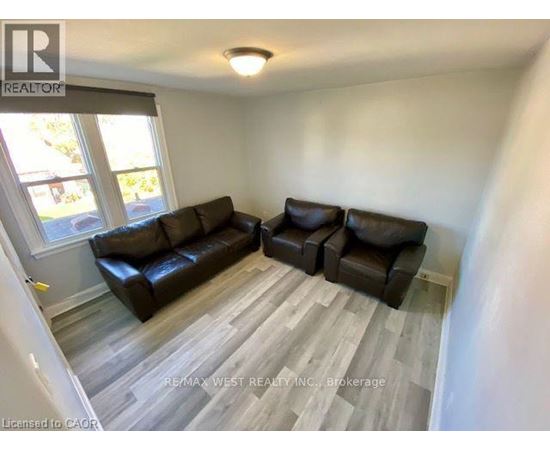 A living room with a couch and a chair.
