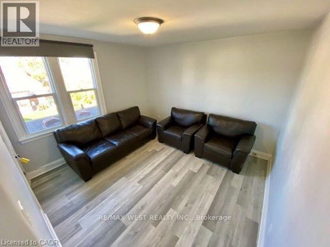 A living room with a couch and a chair.
