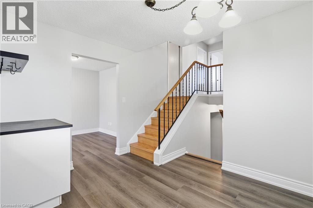 A spacious room with a staircase leading to the upper floor.
