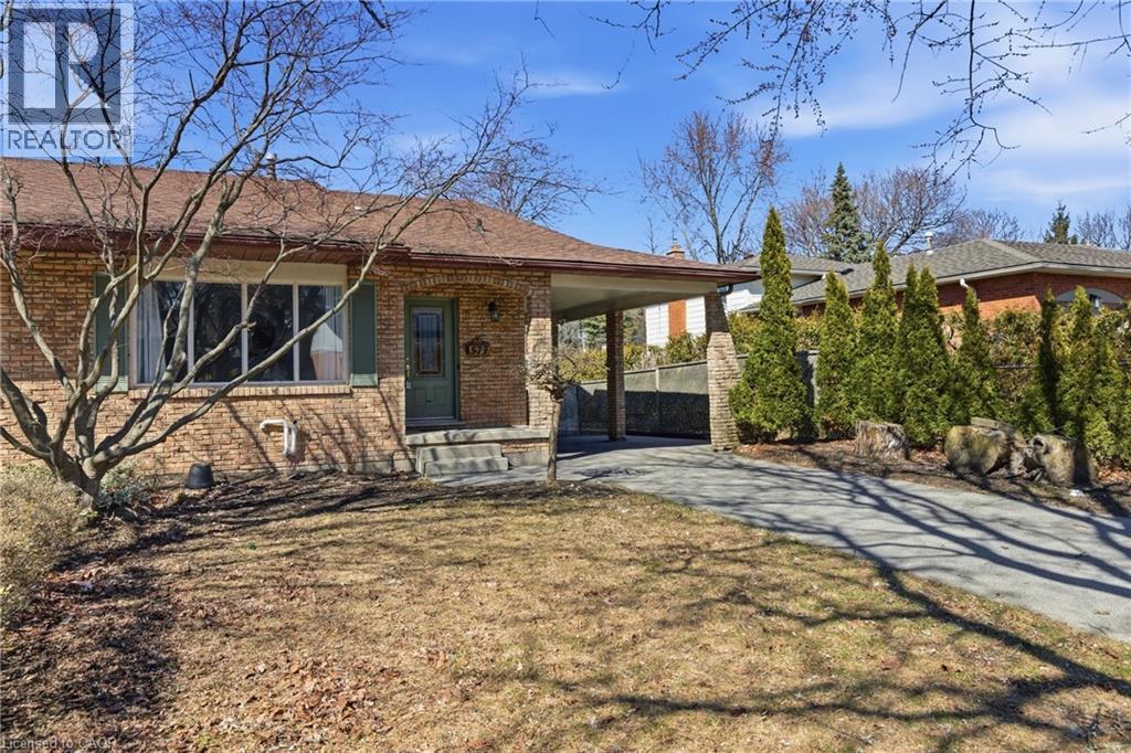 A house with a sign that says REALTOR in the front yard.
