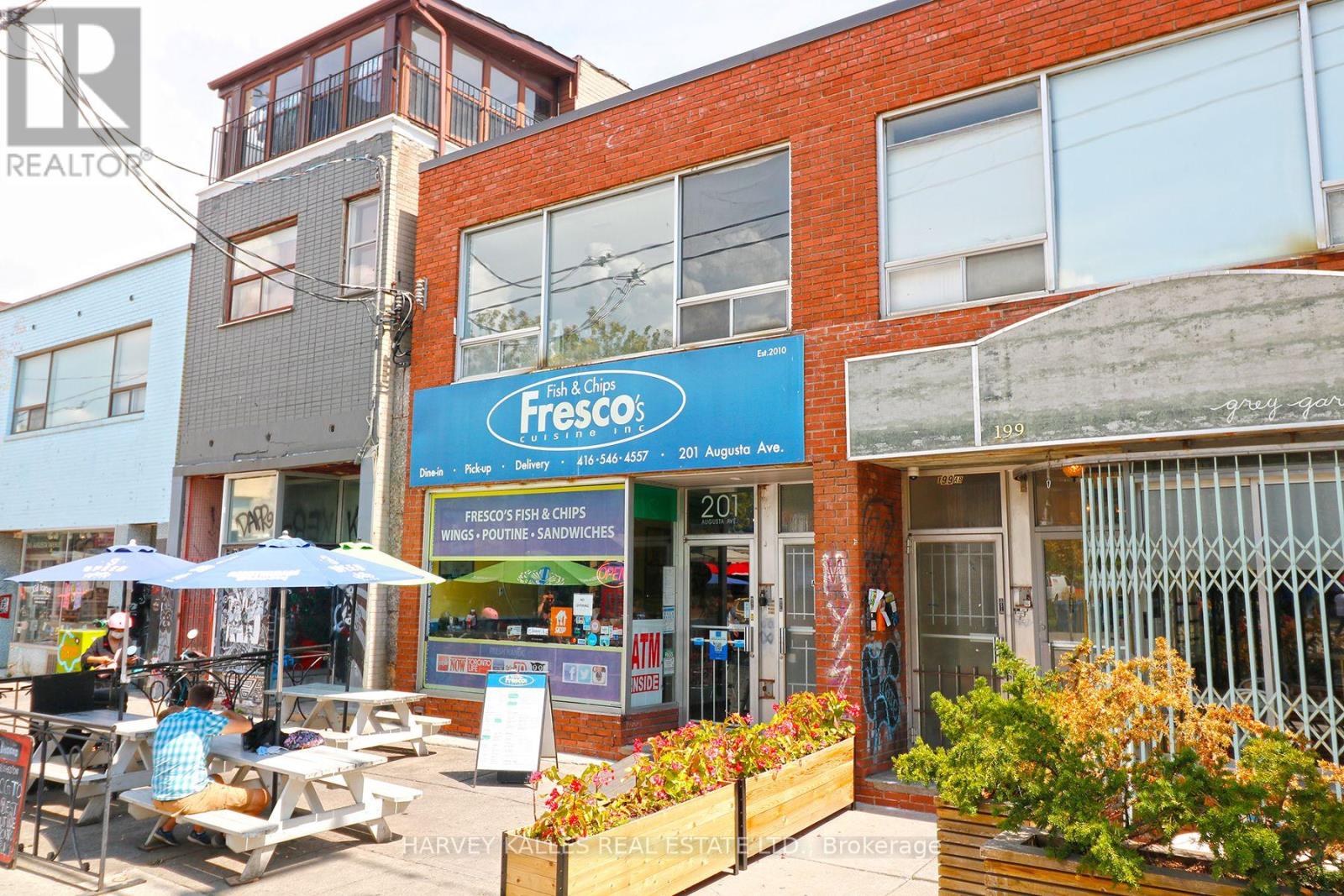 A Fresco fish and chips shop is located in a busy street.