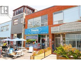 A Fresco fish and chips shop is located in a busy street.