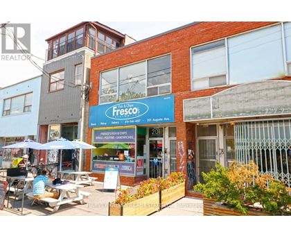 A Fresco fish and chips shop is located in a busy street.