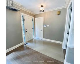 A hallway with a light fixture and two doors.