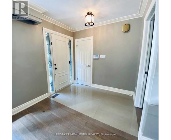 A hallway with a light fixture and two doors.
