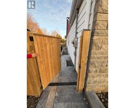 A person peeks through a wooden fence.