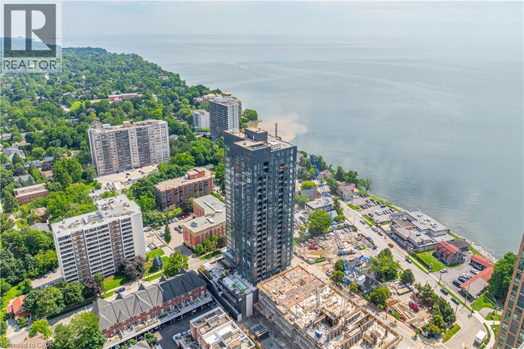 A cityscape with a large body of water in the background and a building under construction in the foreground.