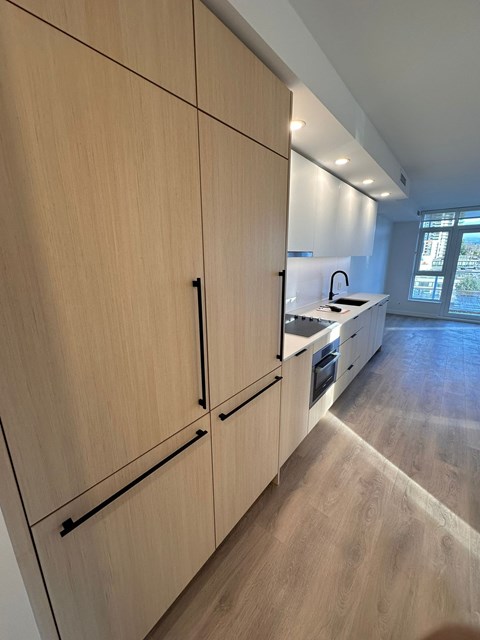 A kitchen with wooden cabinets and a countertop.