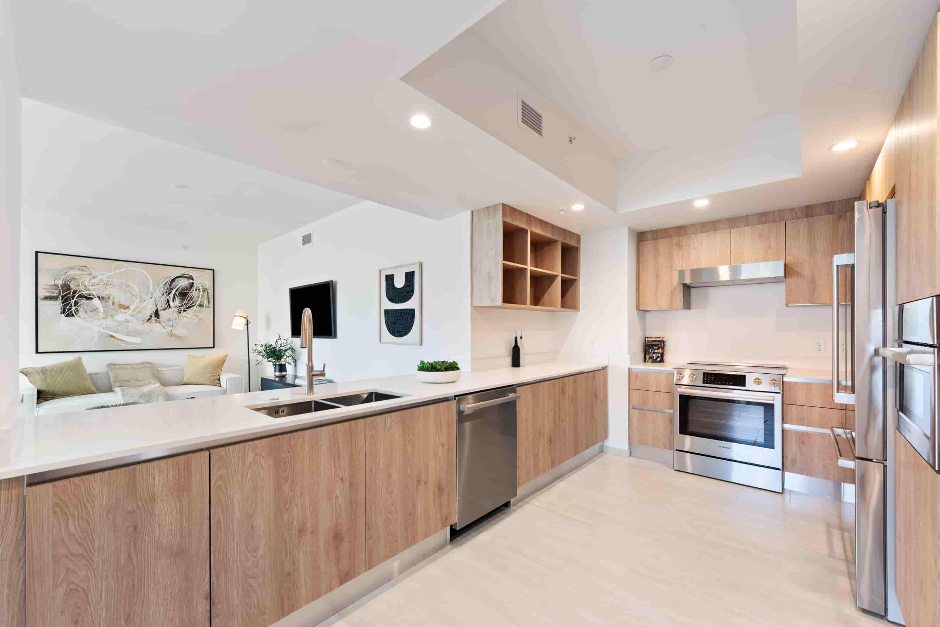 A modern kitchen with wooden cabinets and stainless steel appliances.