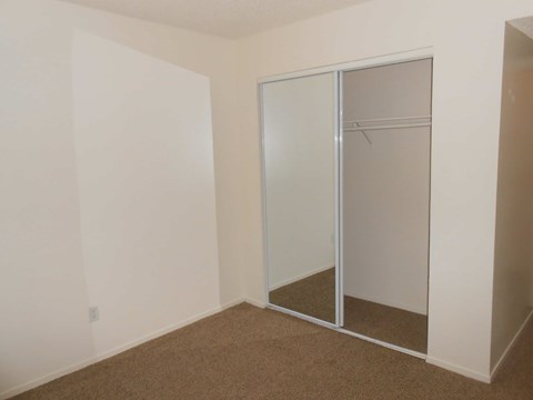 A room with a white wall and a glass door.