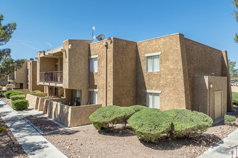 A building with a brown facade and a balcony on the second floor.