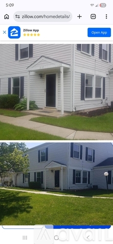A two-story house with a front porch and a garage.