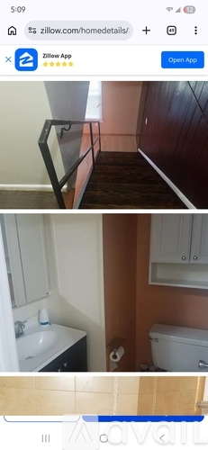 A bathroom with a toilet, sink, and mirror.