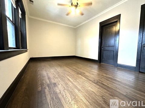 A living room with a brown couch, a chair, and a rug.