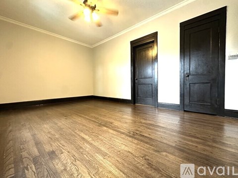 A living room with a chair, couch, and a plant.