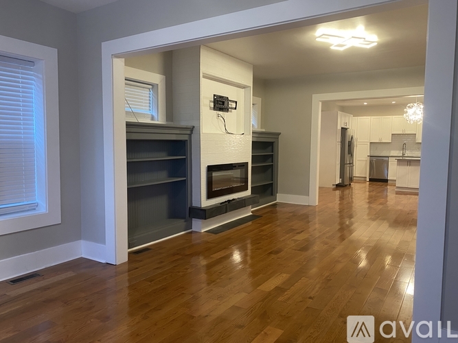 A living room with a fireplace and a TV mounted on the wall.