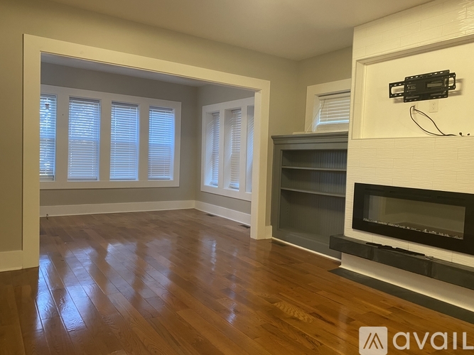 A room with wooden floors and a fireplace.