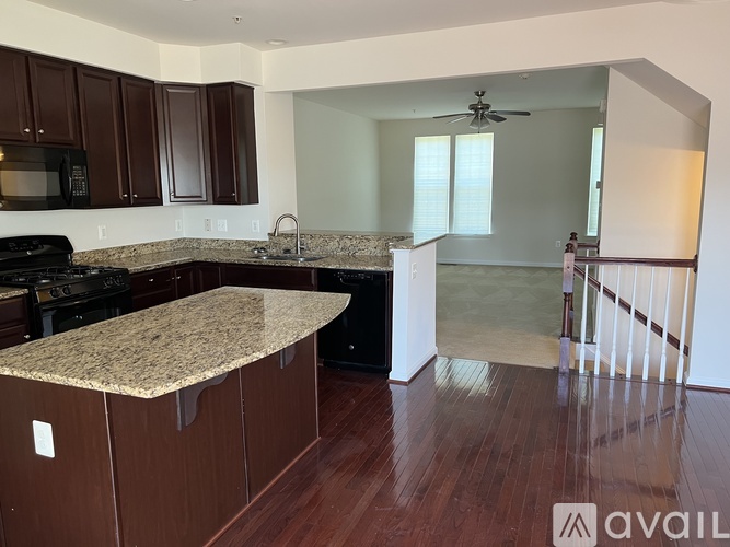 A kitchen with brown cabinets and a granite countertop.