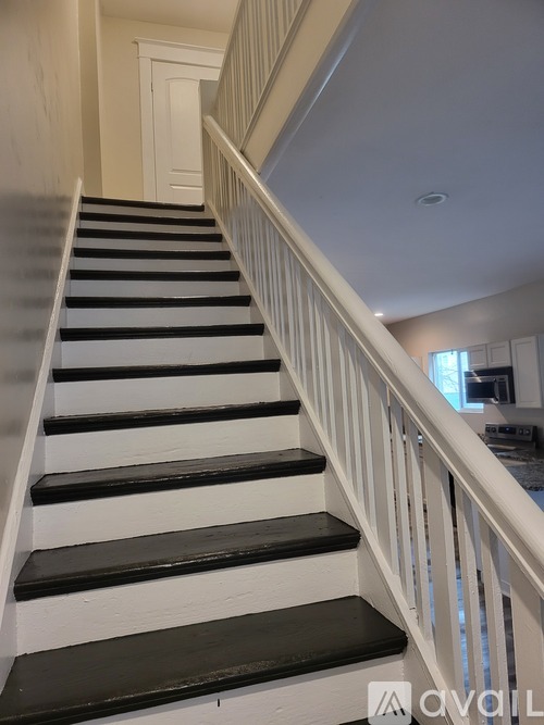 A staircase with black and white steps.