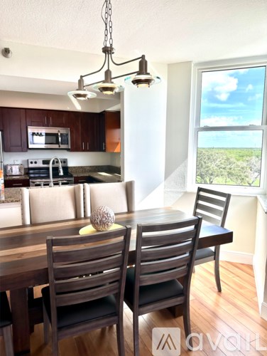 A kitchen with a dining table and chairs.