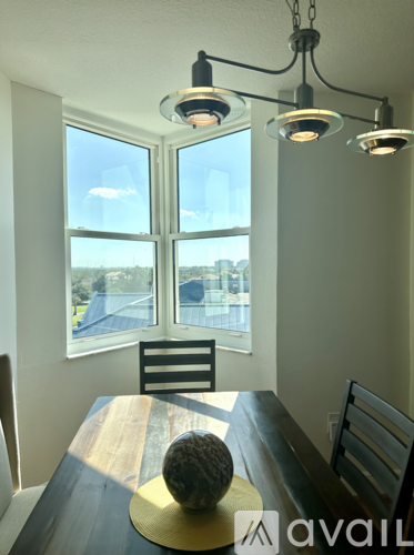 A dining room with a wooden table and chairs.