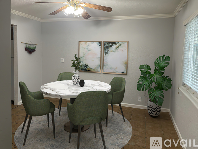 A dining room with a round table and chairs.