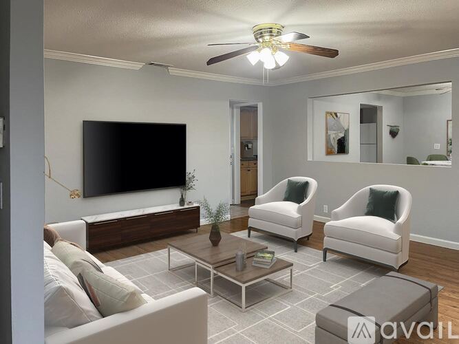 A living room with a flat screen TV mounted on the wall.