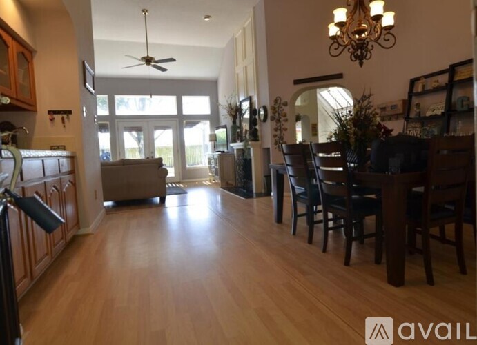 A well-lit dining area with a wooden table and chairs.