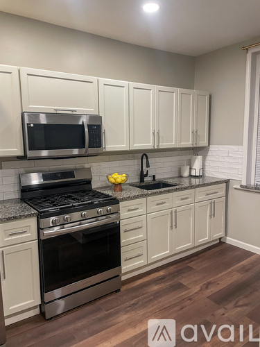 A kitchen with a stove, oven, and cabinets.