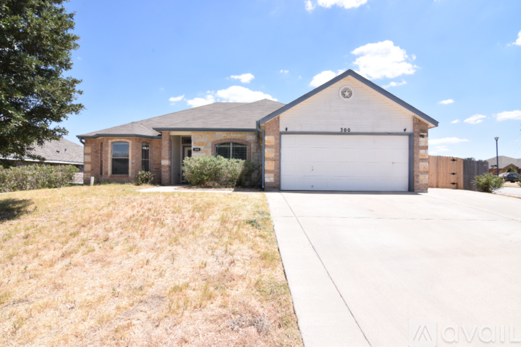 A house with a garage and a driveway in front.