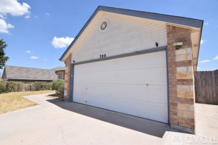 A two-car garage with a brick pillar on the side.