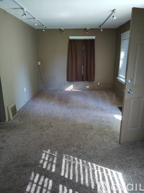 A room with a carpet that has some writing on it.