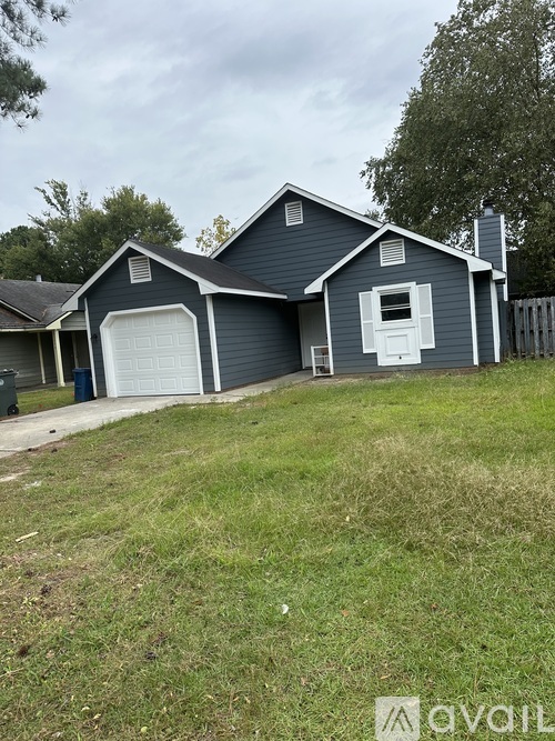 A two-story house with a garage and a chimney.