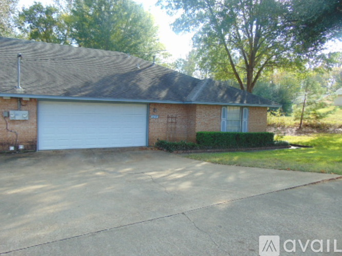 A house with a garage door and a driveway.