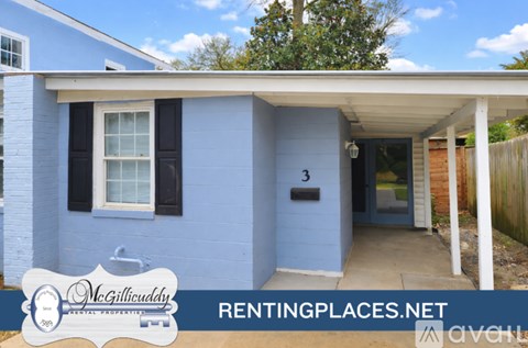 A blue house with a white fence and a sign that says McGillicuddy RENTINGPLACES.NET.