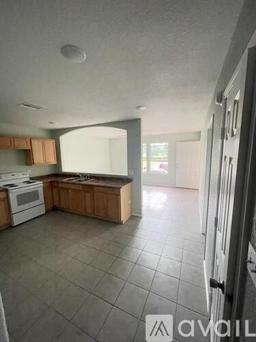 A kitchen with tile flooring and a countertop.