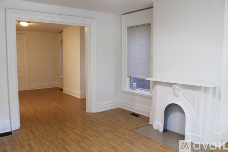 A room with a fireplace and a window.
