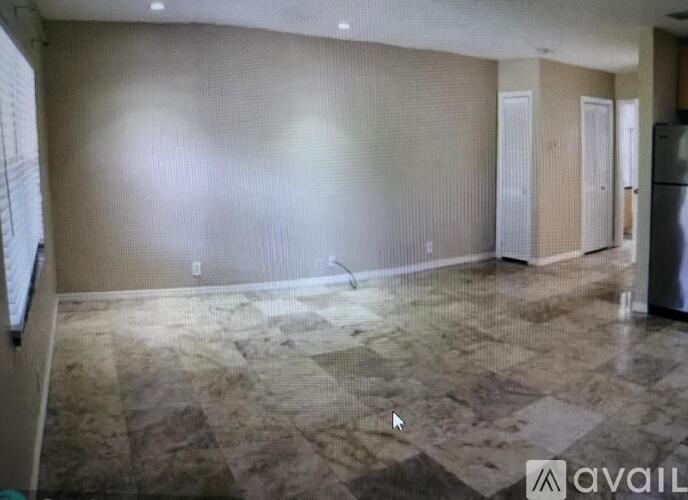 A kitchen area with a refrigerator and a countertop.