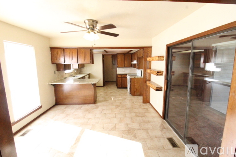 A kitchen with a fan and a table.