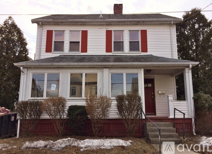 A two-story house with red and white siding and a red door.