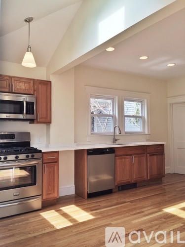 A kitchen with wooden cabinets and stainless steel appliances.