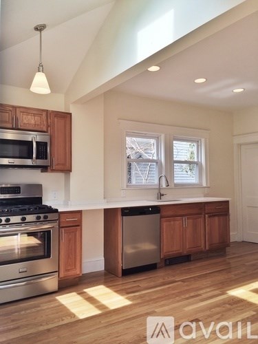 A kitchen with wooden cabinets and stainless steel appliances.