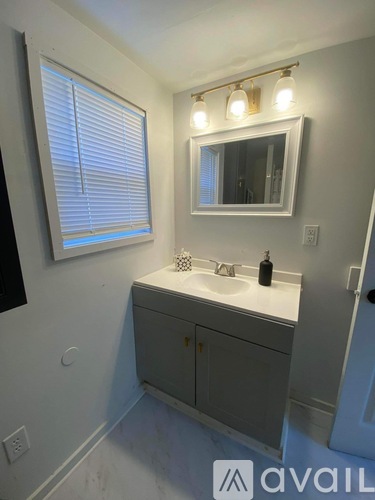 A bathroom with a sink and a mirror.