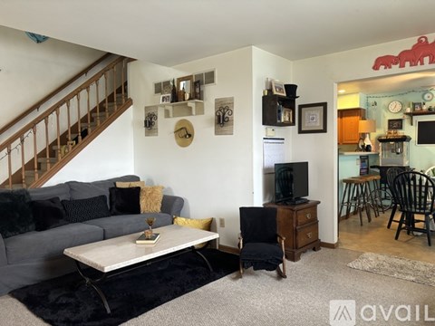 A living room with a grey couch and a white coffee table.