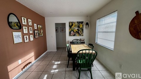 A dining room with a table and chairs.