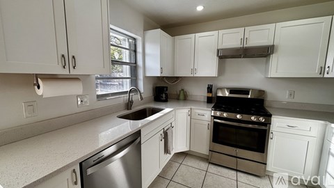 A kitchen with white cabinets and stainless steel appliances.