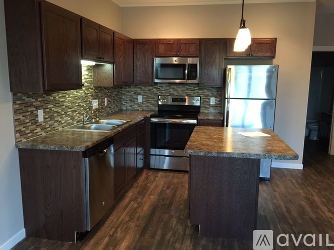 A kitchen with wooden cabinets and granite countertops.